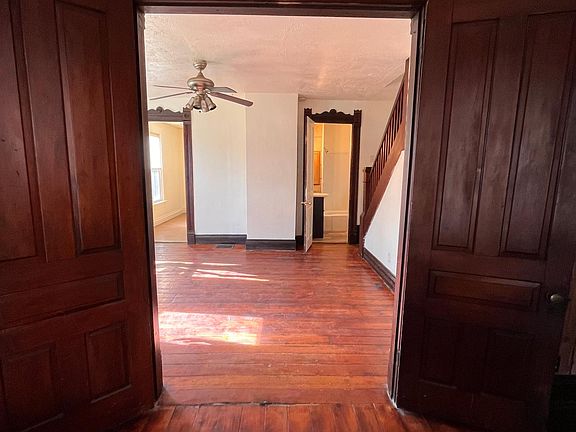 1st floor Master bedroom facing living room, kitchen to left, bathroom to the right