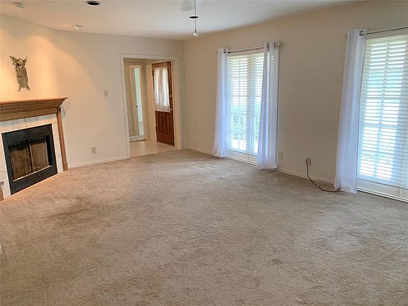 Floor-to-ceiling windows for plenty of natural light in living room. Gas fireplace. Recessed lights.