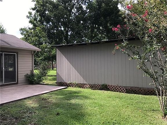 Shady backyard with a storage shed