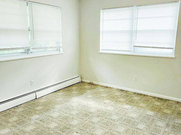 Bedroom 1 with double windows and ceiling fan