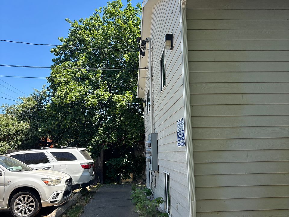 Paved walkway on the side of property including off street parking.