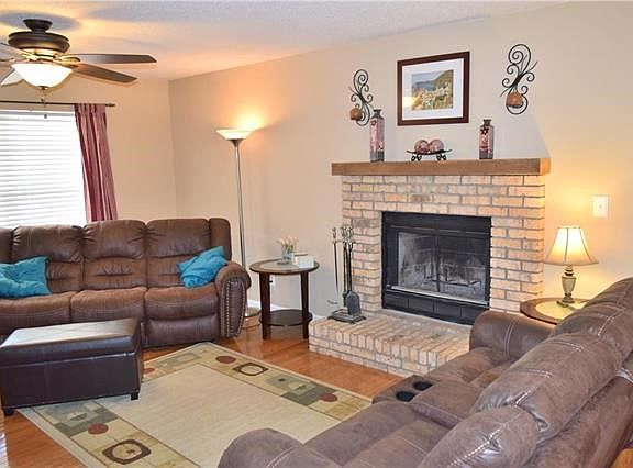 Living room boosts a wood burning fireplace and opens to the dining room.