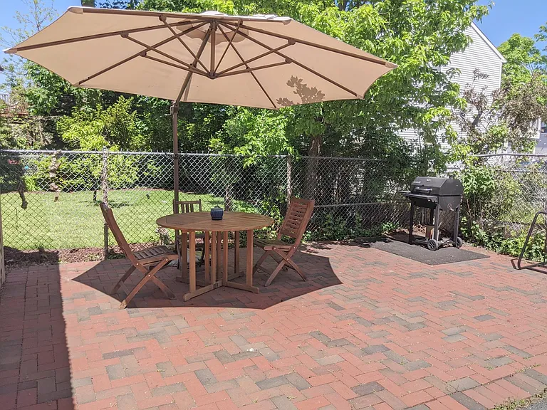 Outdoor patio area with charcoal grill