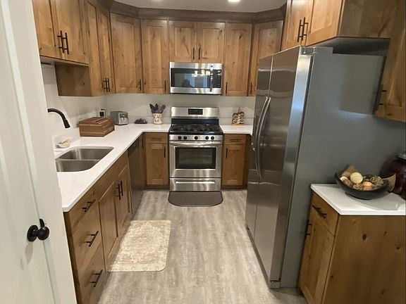 Kitchen with quartz counter top and Knotty Alder Cabinets