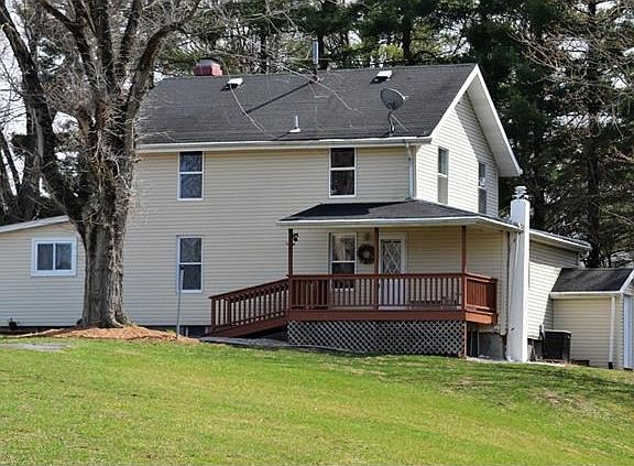 Charming farmhouse has covered front porch.