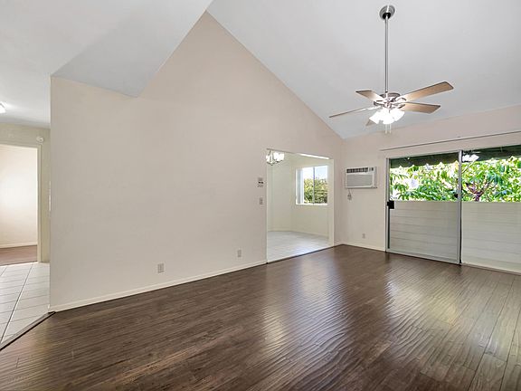 Living Room with Vaulted Ceilings, Fire Place, Heater, Air Conditioner and Ceiling Fan