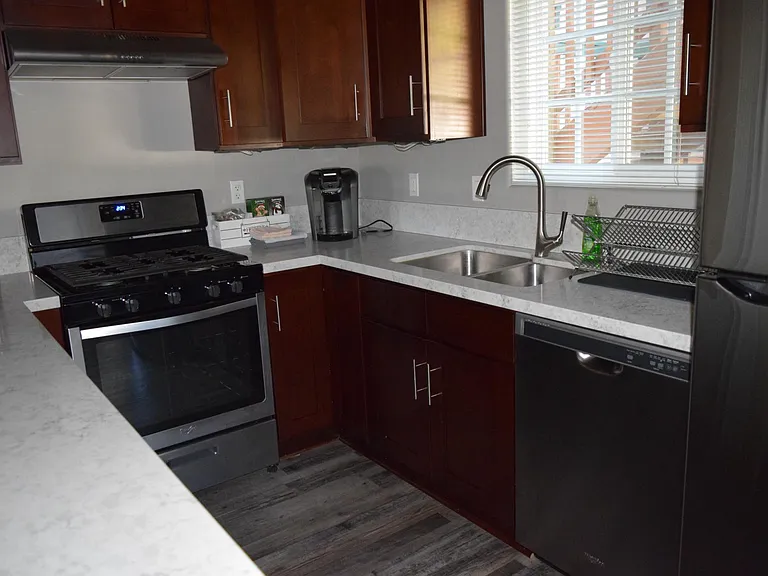 This kitchen is equipped with stainless steel appliances and over the range venting and lighting. Plus, there is under cabinet lighting.