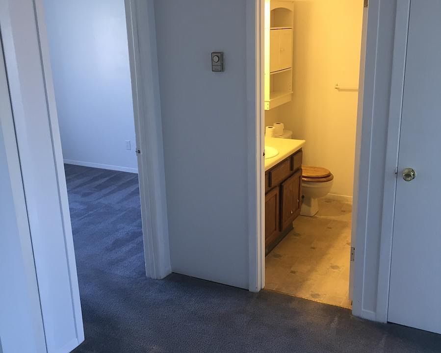 Hallway catching glimpse of back bedroom