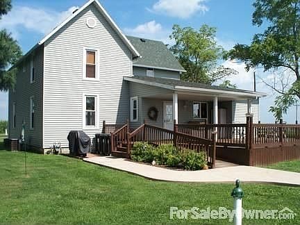 Rear View of the Home : Large deck, wheelchair ramp, new landscaping, brick area for grill