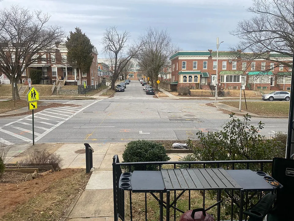View from the front porch of the apartments with parking all day across the street