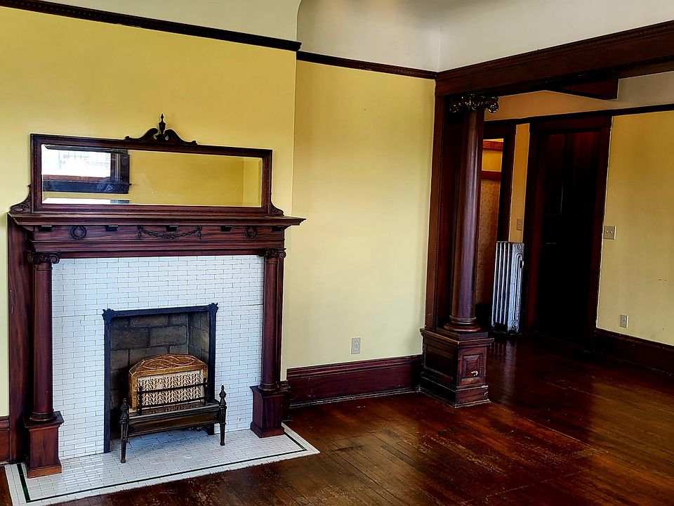 Original woodwork, tiled and mirrored mantel in front, great room