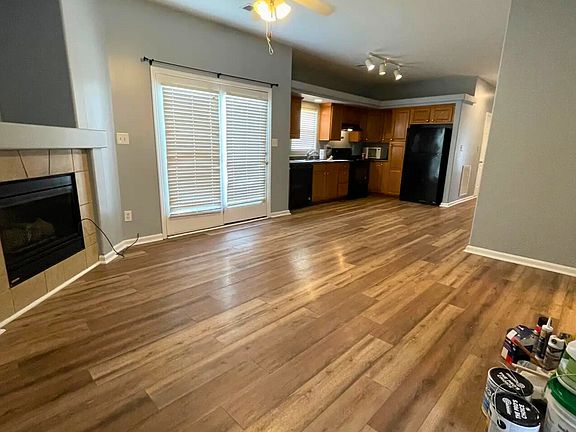 Open-concept living and kitchen area with luxury vinyl plank flooring and abundant natural light.