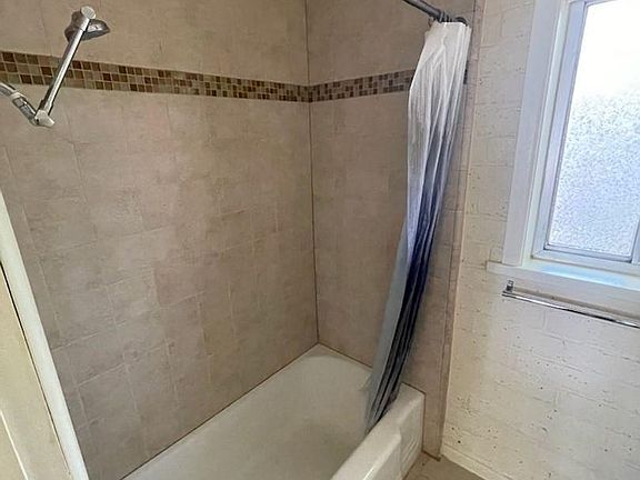 Full bath with tiled shower/tub.