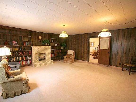 Large Den with gas log fireplace and built in bookshelves. Could easily be con