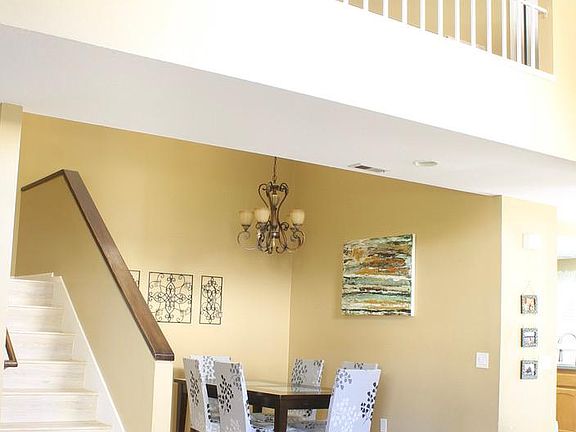 Home entryway overlooking the dining area. High ceiling with couple Sky lights