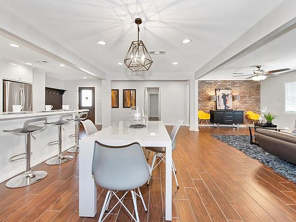 Wonderful Open Floor plan with view of the dining room, living room and kitchen! Notice the long breakfast bar.
