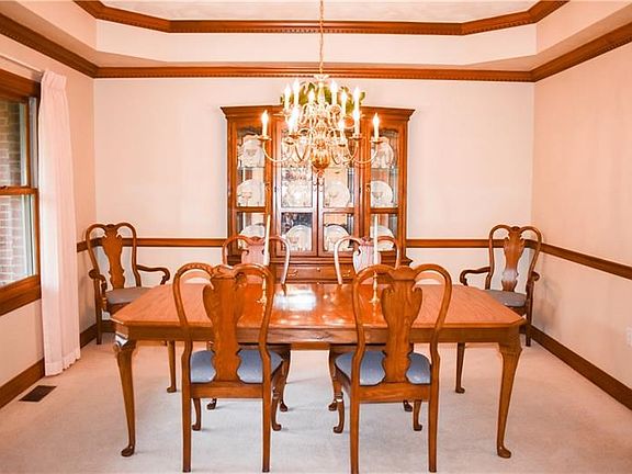 Dining with double dentil crown mouldings to accent the tray ceiling and custom medallion.  Chair rail accents too.