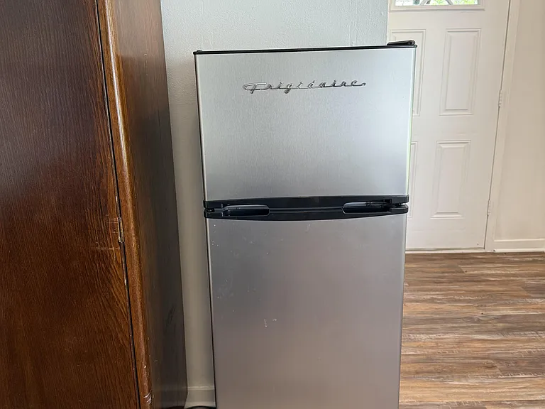 Apartment size fridge in room