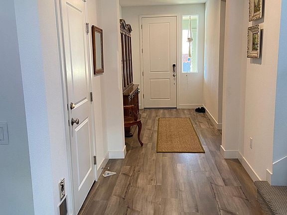 Main hallway to stairway and Garage Access and Cat door.