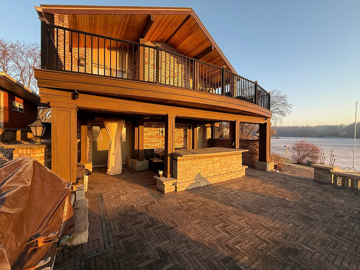 Exterior showing expansive brick paver patio and Trex deck. - 8473 Woodland Shore Dr