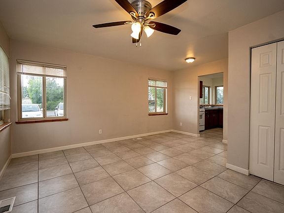 Standing at front door in living room looking into kitchen (stacked washer and dryer in closet)