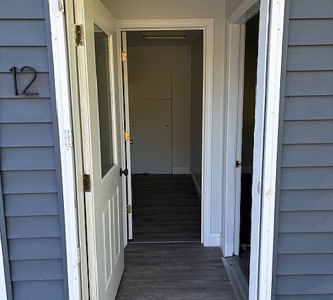 Enter into a small mudroom. Ahead is a private utility room. Entrance to the living room is to the right.