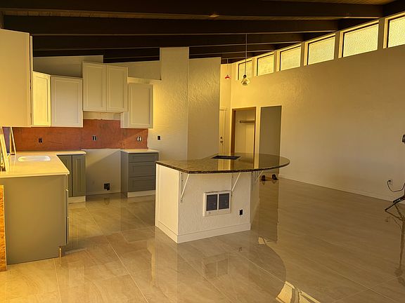 Large kitchen with new cabinets and granite countertops. New Tile floors, new paint