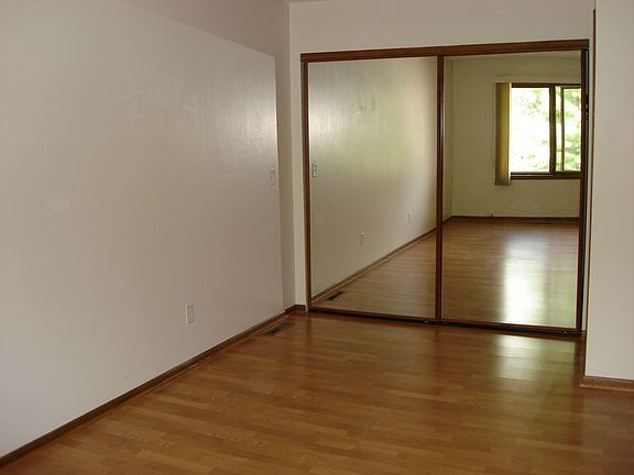View of master bedroom and glass doors covering walk-in closet