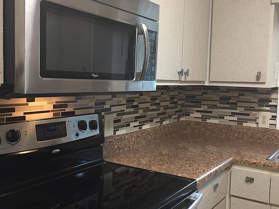 Carefree Kitchen - great appliances: solid surface, self cleaning stove, and microwave/vent above. New laminated cabinet doors. cabinet doors