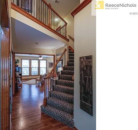 Entryway view...Designer Carpet & Iron Spindles on Stairs!