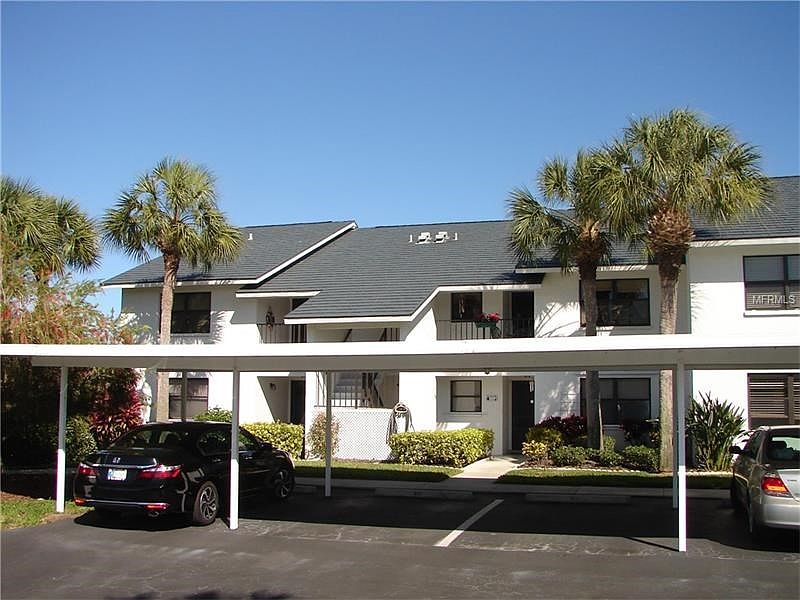 Exterior front of building with assigned covered parking space.