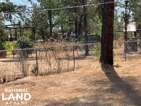 FENCED YARD WITH PLAY EQUIPMENT