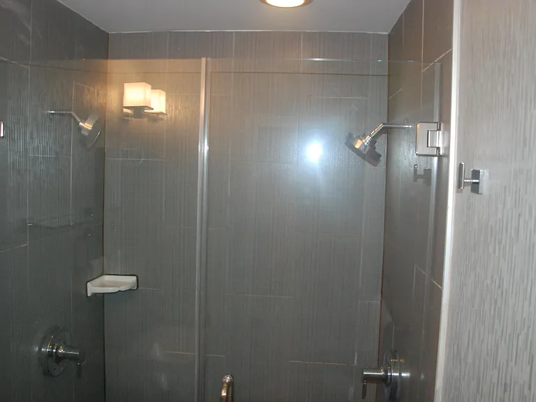 Luxury dual shower with floor-to-ceiling tile.