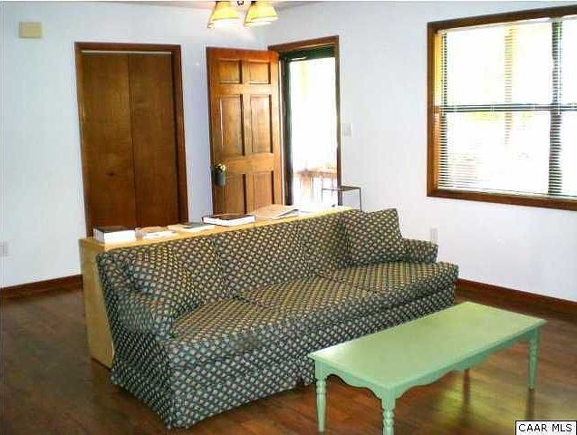 Living room, coat closet and front door to porch