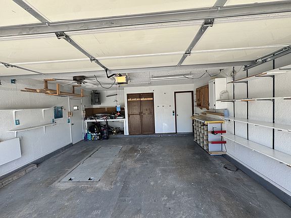 Storm Shelter! Plenty of shelving for storage in this 2 car garage.