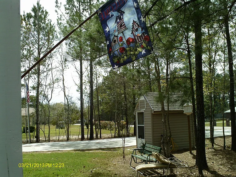 Well-house in front yard, paved drive...
