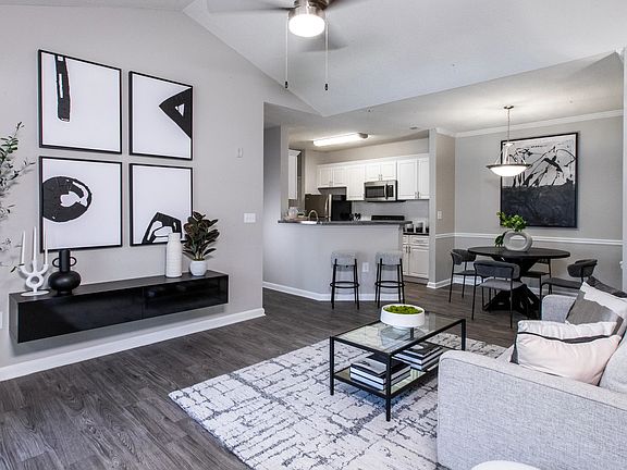 Delight in the luxury of our expansive living rooms featuring rich wood-style flooring and modern ceiling fans with lights.