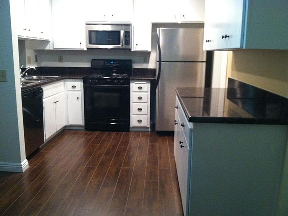 Kitchen has new grey flooring not brown