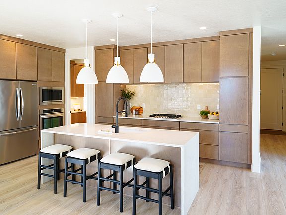 Modern kitchen from the Contempo Collection with light wood cabinets, stainless steel appliances, a