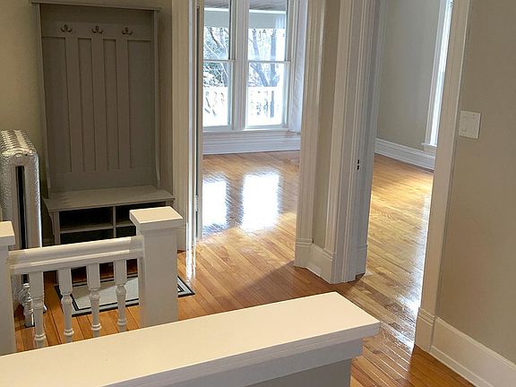 The front staircase leads to a mezzanine with a handy coat rack and shoe bench.