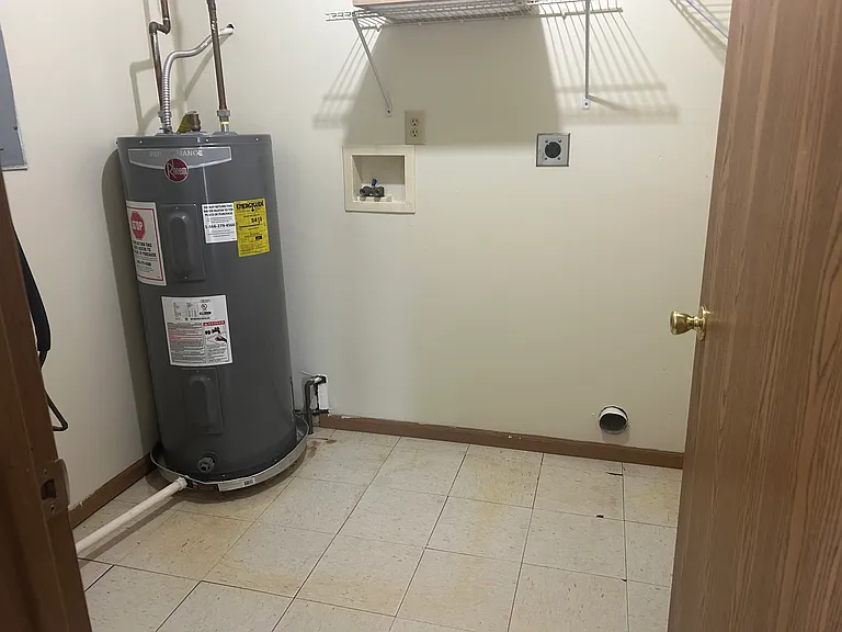 Utilities closet with washer and dryer hook up