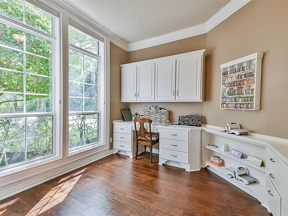 Left of the foyer is the office/study/craft room with custom built-in cabinets.