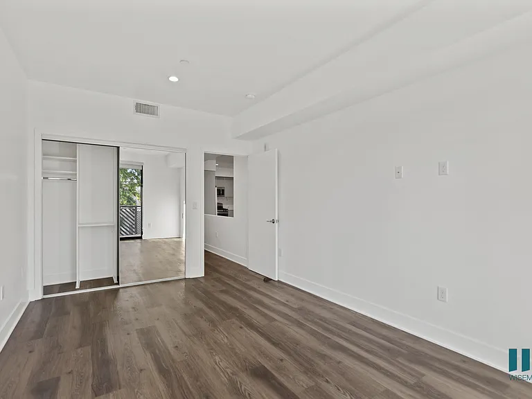 Bedroom with Mirrored Closet, Recessed Lighting, and Vinyl Flooring