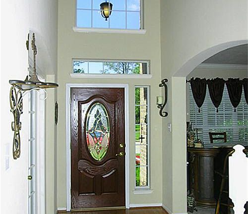 Inviting Entrance with wood flooring, Study with French Doors, Formal dining room.