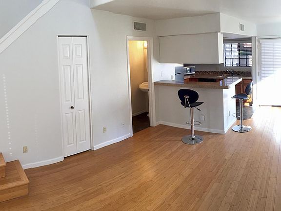 Living Room & Kitchen with access to patio through double french doors. Half bath on ground floor. 2 closets downstairs.