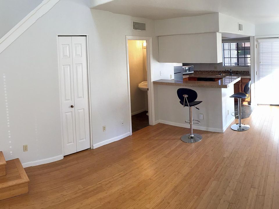 Living Room & Kitchen with access to patio through double french doors. Half bath on ground floor. 2 closets downstairs.