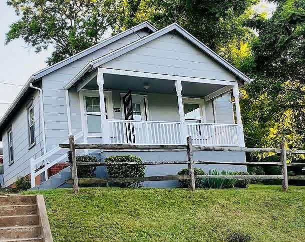 Front of house. Will have 2 white wooden rocking chairs and small side table when weather allows