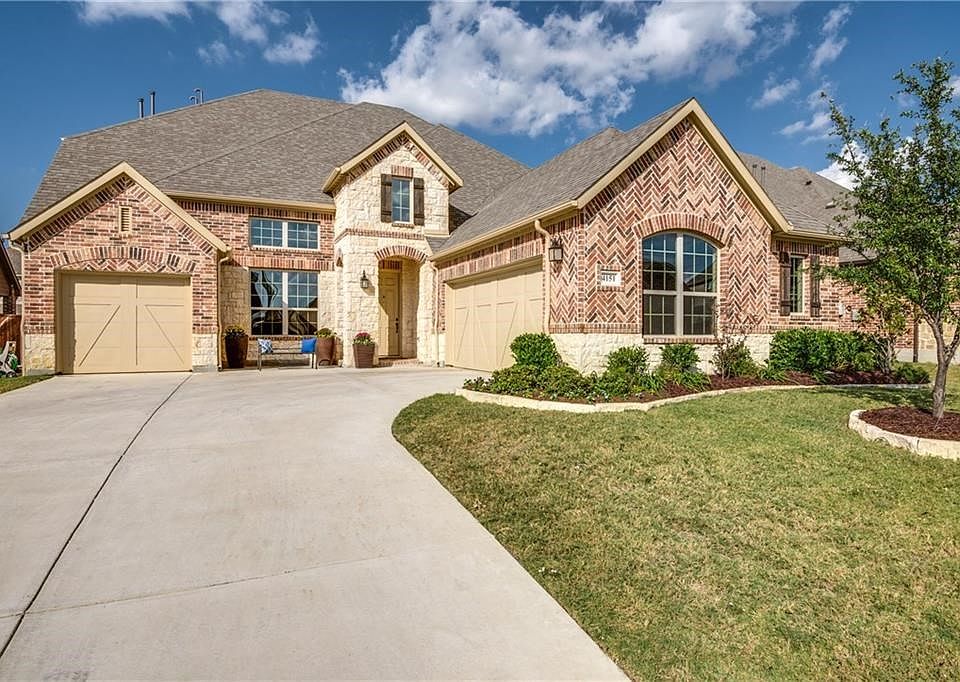 Beautiful Drive up with stone & brick elevation, long swing driveway, 3 car garage and professional landscaping!