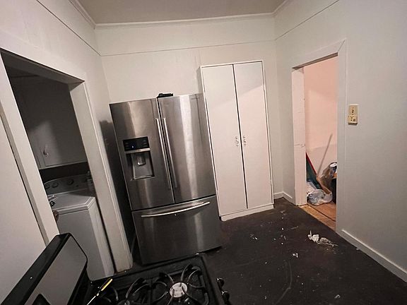 kitchen , with view of the back door area , equips with washer (no dryer)