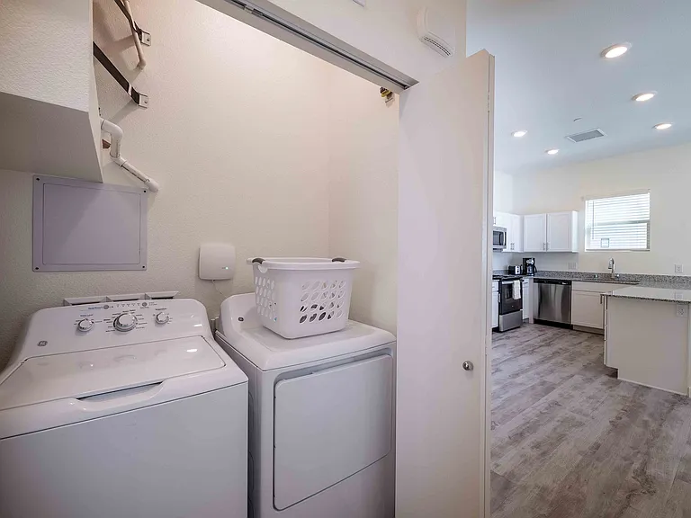 Experience convenience and style with an integrated kitchen and laundry space.